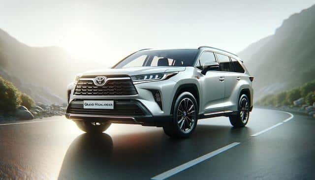 A silver SUV on a winding mountain road at sunrise.